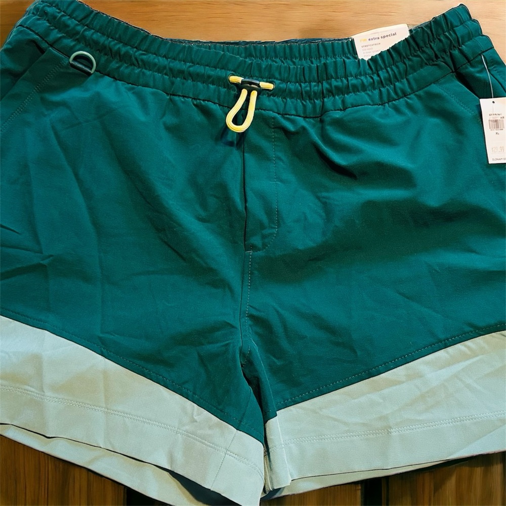 2 pairs of Old Navy stretchy board shorts. One green, one orange.